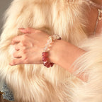 wearing-strawberry-quartz-bracelet-with-gold-accents
