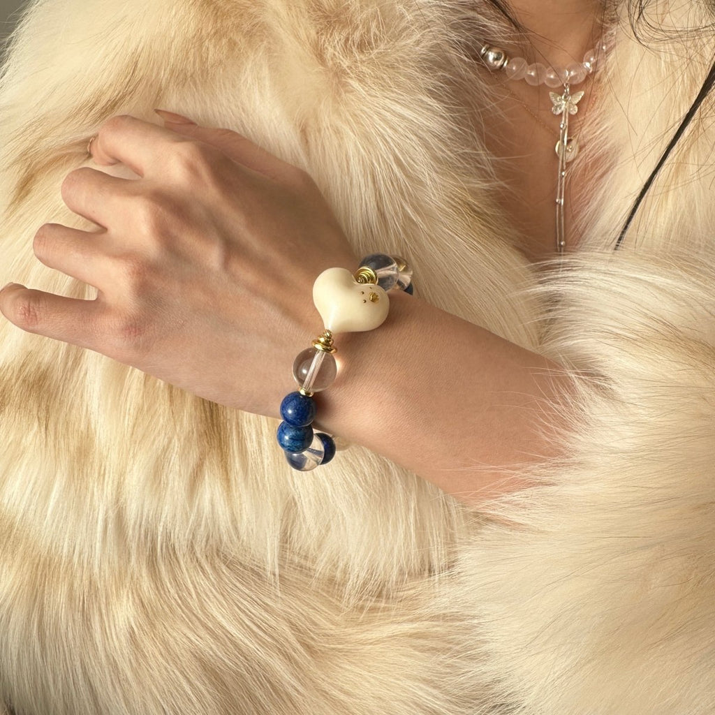 wearing-lapis-lazuli-bracelet-with-white-heart-charm