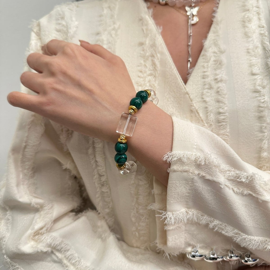 wearing-malachite-bracelet-with-gold-accents-for-transformation