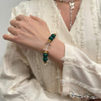 wearing-malachite-bracelet-with-gold-accents-for-transformation