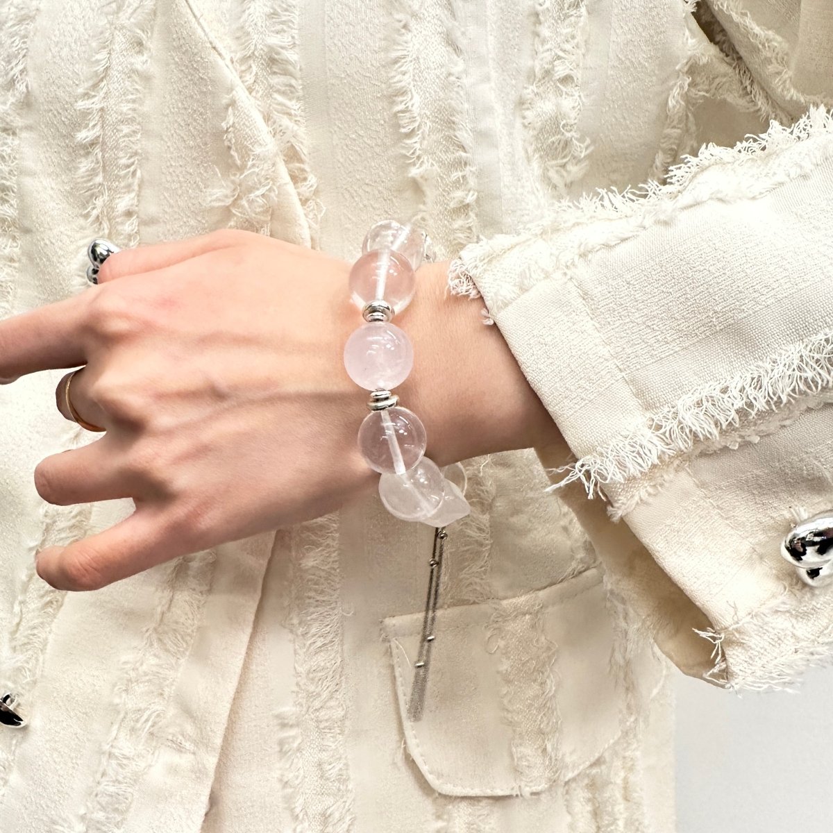 wearing-large-bead-rose-quartz-bracelet-with-wing-charm