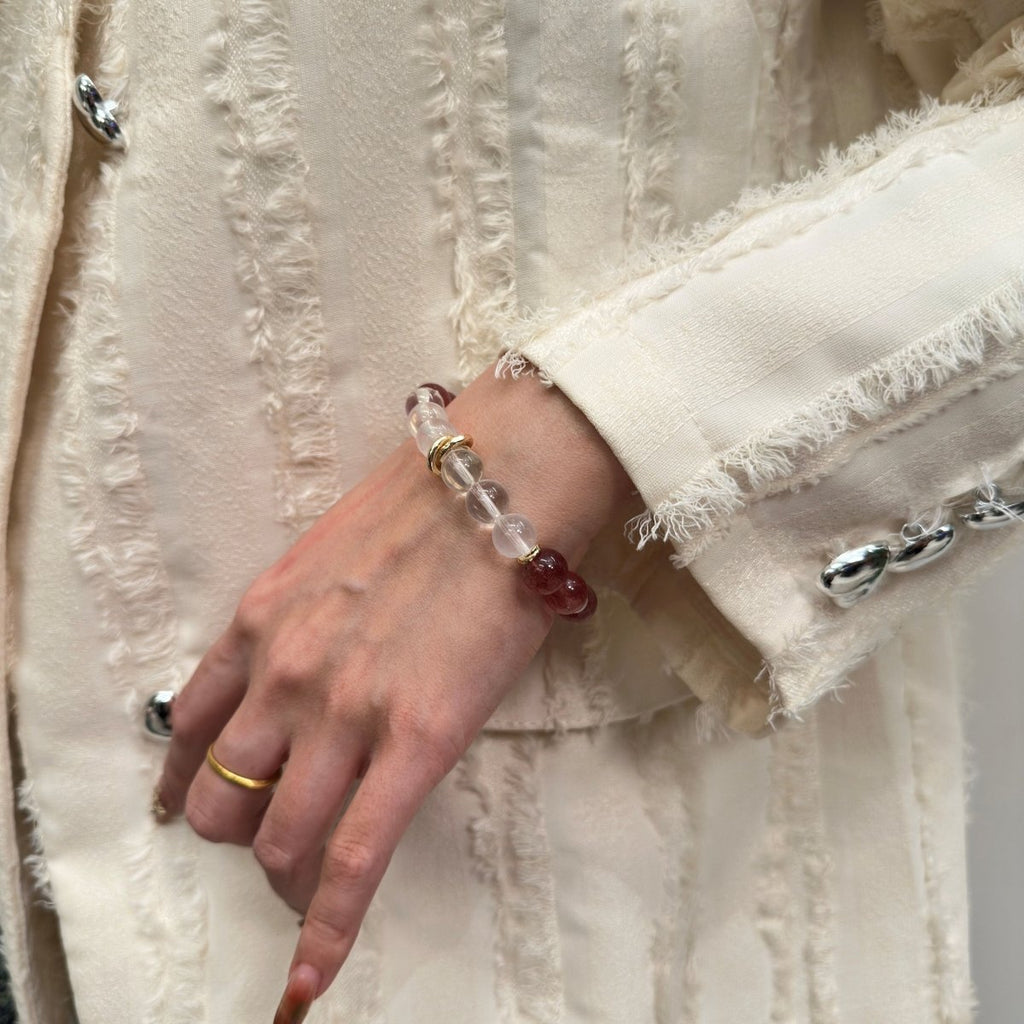 wearing-strawberry-quartz-bracelet-with-gold-accents